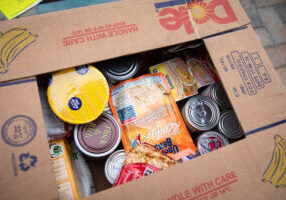 food staples packed in box at California food pantry symbolizes giving to humanitarian causes