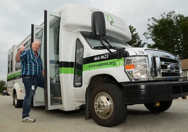 Bus driver walks onto Opportunity Enterprises bus